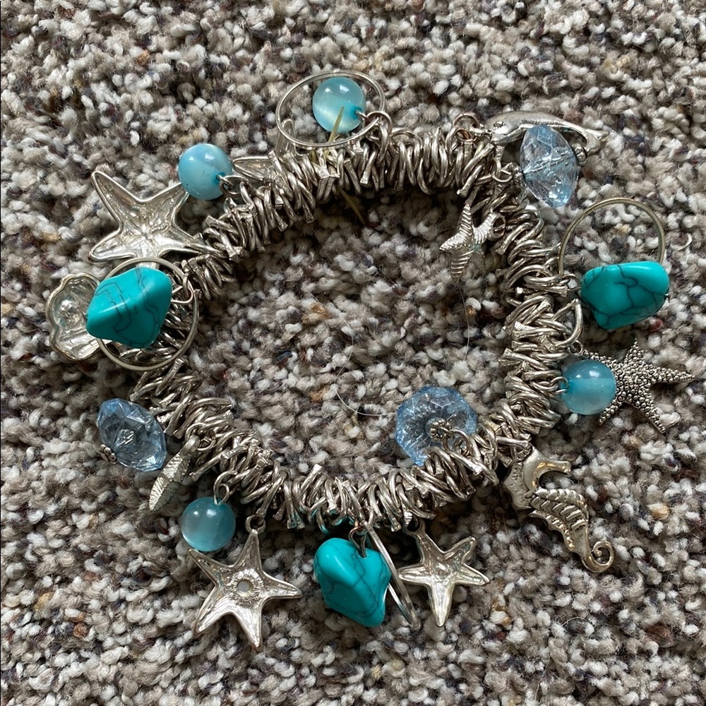 Charm bracelet beach, by the sea motif, with shell, star, seahorse & dolphin.